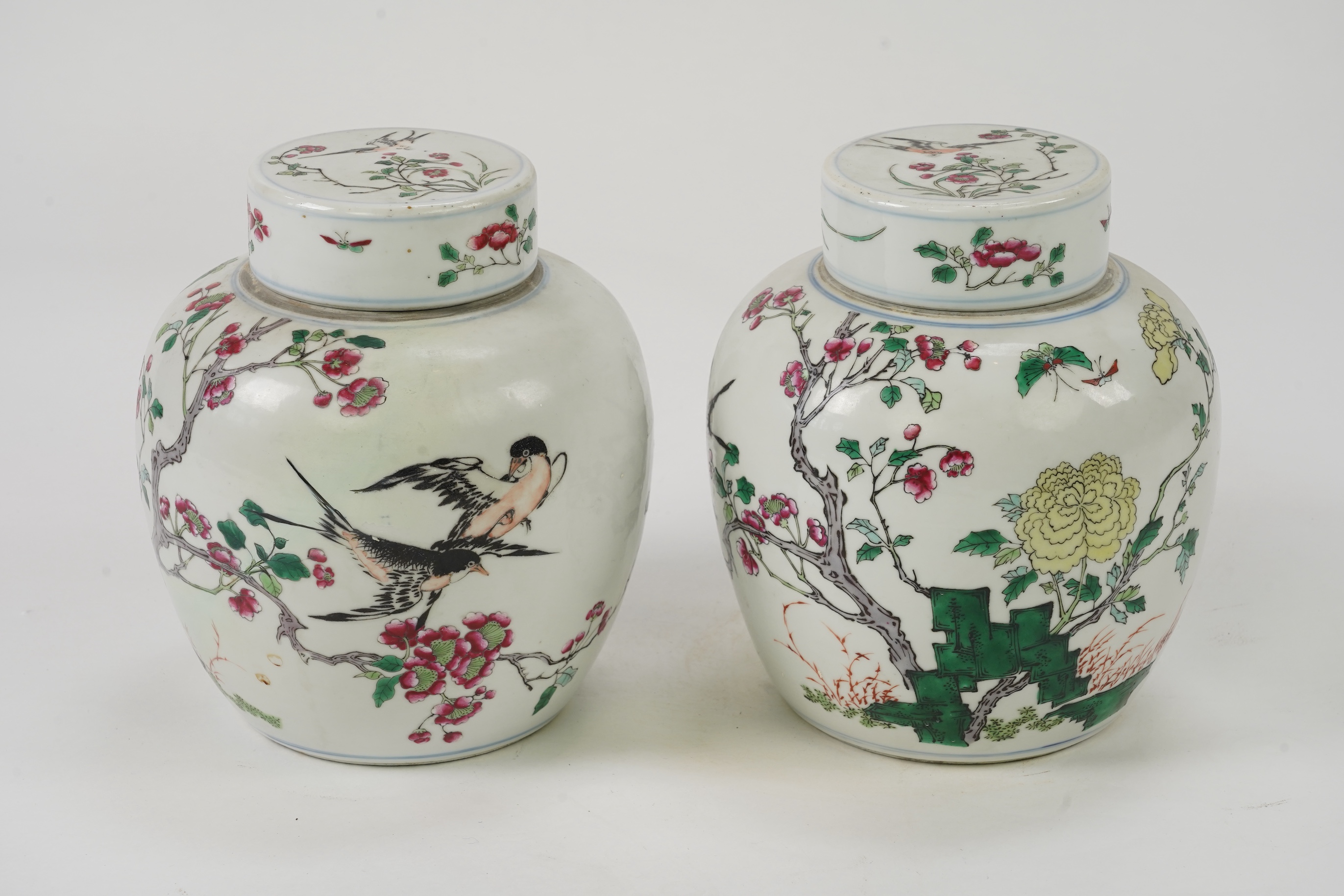 A pair of Chinese famille rose jars and covers, Kangxi mark but late 19th/early 20th century